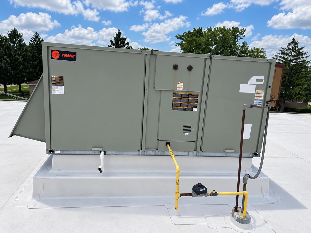 Packaged rooftop heating and cooling unit on a commercial roof